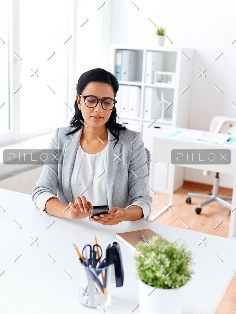 demo-attachment-71-businesswoman-messaging-on-smartphone-at-office-P5AQU8Y